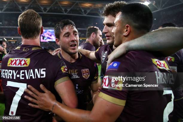 Ben Hunt of Queensland and team mates celebrate winning game three of the State of Origin series between the Queensland Maroons and the New South...