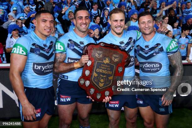 Tyson Frizell, Paul Vaughan, Jack de Belin and Tariq Sims of the Blues pose with the trophy after winning the series following game three of the...