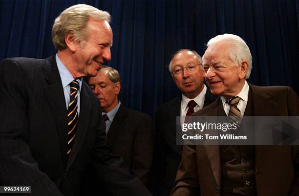 Sen. Joe Lieberman, D-Conn., gives a word of support to Sen. Robert Byrd, D-W.V., after he spoke at a news conference with a bipartisan group of...