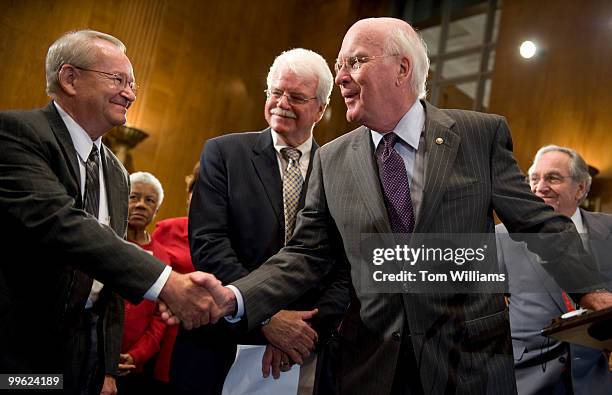 Sen. Pat Leahy, D-Vt., shakes hands with Jack Gross whose age discrimination case Gross v. FBL Financial was decided against by the Supreme Court,...