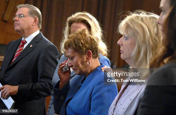 Carol Blocker, whose daughter committed suicide after suffering from postpartum depression, is comforted by Susan Stone, Postpartum Support...