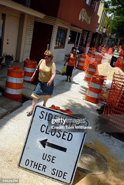 Pedestrians make there way down a stretch of Pennsylvania Ave., SE, that is undergoing repairs.