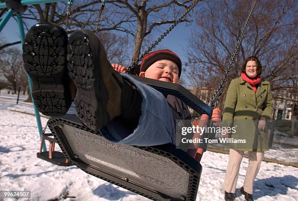 Griffith Barton, 19 months, gets a push from babysitter Liz Hammond while playing on a swingset in Garfield Park, near F and 2nd St., SE.