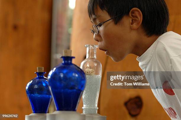 Kenton Kwok of California, smells samples of herbal ingredients such as peppermint, jasmine and patchouli, as part of an herbal medicine...