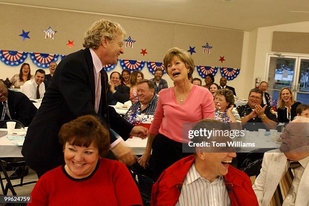 Potential Senate candidate Jerry Springer, D-Ohio, comforts Sheila Madru after she lost an auction on his tie at the Ross County Democratic Party...
