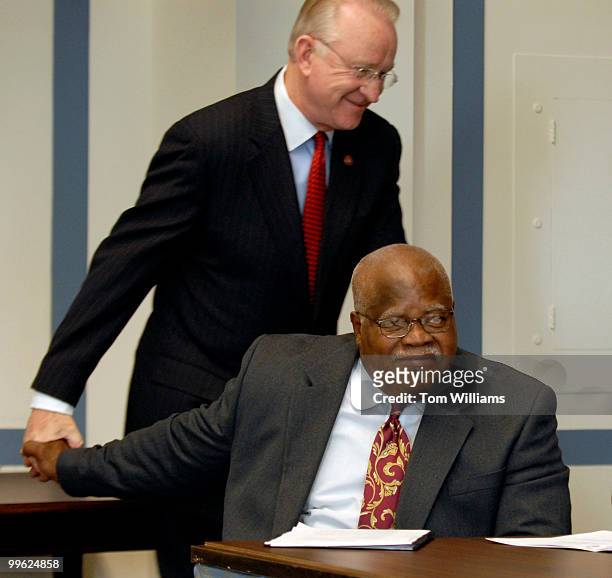 Reg Weaver, sitting, president of the National Education Association greets Rep. Buck McKeon, R-Calif., at a news conference to urge Congress to act...