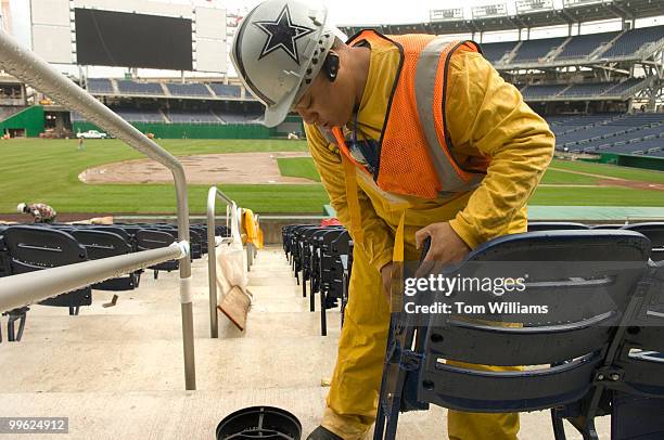 Shirley Boykins installs seats at the new Nationals Stadium.