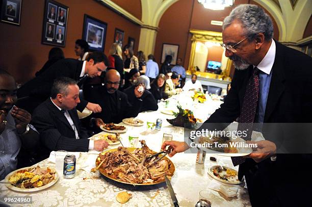 Tony Harrison, Director of Outreach, for House Majority Whip James Clyburn, D-S.C., helps himself to turkey during 10th annual Thanksgiving dinner...