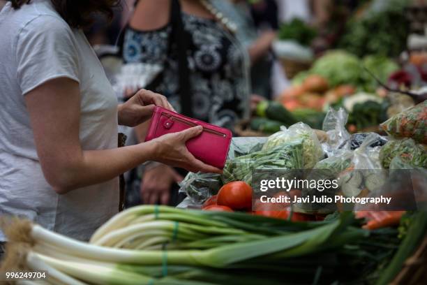 people shoping at a traditional outdoor fruit and vegetable market in san sebastian, spain - fresh deals ストックフォトと画像