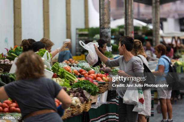 people shoping at a traditional outdoor fruit and vegetable market in san sebastian, spain - fresh deals ストックフォトと画像