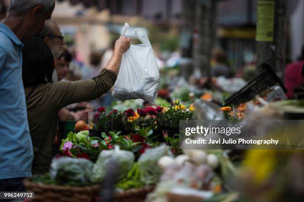 people shoping at a traditional outdoor fruit and vegetable market in san sebastian, spain - fresh deals stockfoto's en -beelden