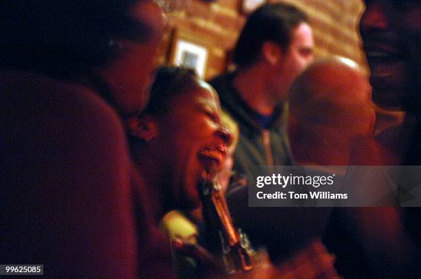 From left, Crystal Ellerbe, Lisa LeVert, and Ramon Long, share a laugh on opening night of the Pug on H street, NE.