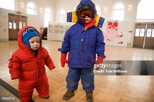 Jasper Madland and his brother Charlie pose for a picture in Eastern Market before heading out into the winter storm expected to bring 10-15 inches...