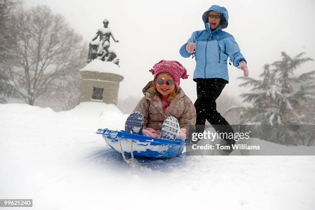 Chapin Magee gets a push from her mother Sarah von der Lippe in Lincoln Park during a winter storm expected to bring 10-15 inches of snow in the...