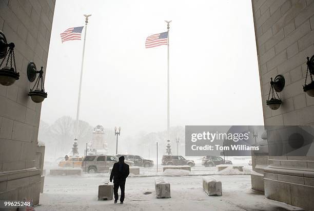 Flags whip outside of Union Station during a winter storm expected to bring 10-15 inches of snow in the District with gust of winds near 40 miles per...