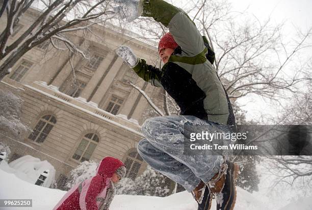 Ethan Johnson and his sister Camilla of Capitol Hill, play on a pile of snow on 1st. St., SE, during a winter storm expected to bring 10-15 inches of...
