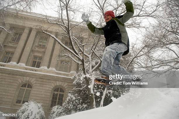 Ethan Johnson of Capitol Hill, jumps off a pile of snow on 1st. St., SE, during a winter storm expected to bring 10-15 inches of snow in the District...