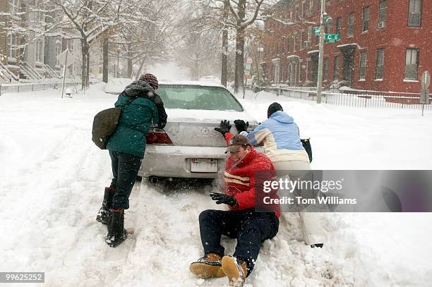 Doug Heye, communications director for the RNC, loses his footing while trying to push a car on 3rd, St., SE, during a winter storm expected to bring...