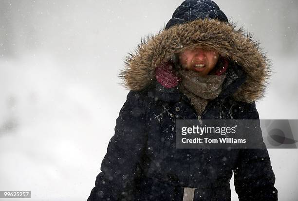 Maria Fruchiano makes her way down 7th St., SE, during a winter storm expected to bring 10-15 inches of snow in the District with gust of winds near...