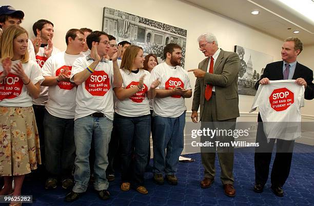 Rep. George Miller, D-Calif., talks to students as Rep. Chris Van Hollen, D-Md., holds a new tee shirt, during a rally by students from D.C. Colleges...