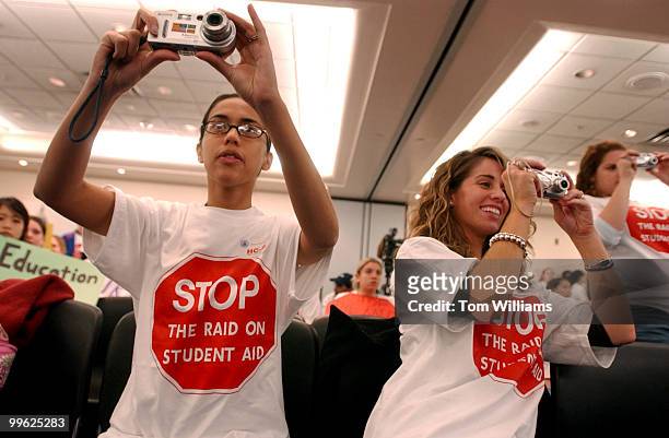 Priscilla Crisologo, left, an Georgetown alum, and Lauren Murray, and George Washington University junior, take pictures at a rally by students from...