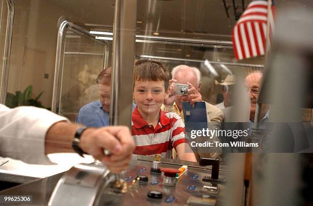 Matt Marti of Cleburne, Texas, checks out the control board of a subway car on ride from the Capitol to Rayburn Building while family friend Rick...