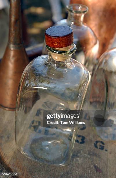 Reproduction glass bottles sit near a still at George Washington's Gristmill at the Mount Vernon Estate, before a ceremony to lay a cornerstone at...