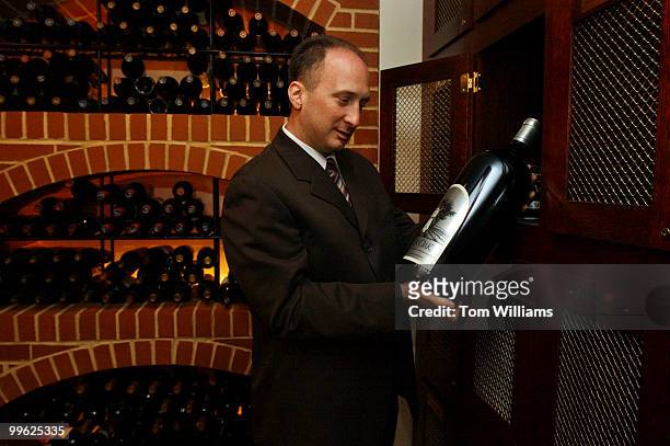 Daniel Festa of Morton's SteakHouse, on Conn. Ave., pulls wine out a wine locker that the have in the establishment. The giant bottle is equivalent...