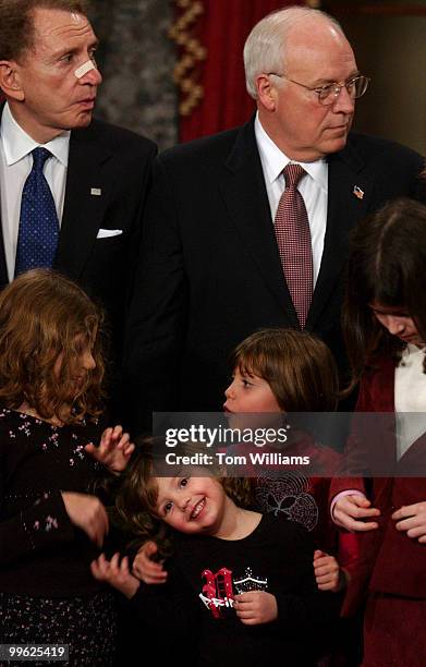 Sen. Arlen Specter, R-Pa., prepares to be sworn into the 109th Congress by Vice President Dick Cheney, while his grandchildren fool around. From left...