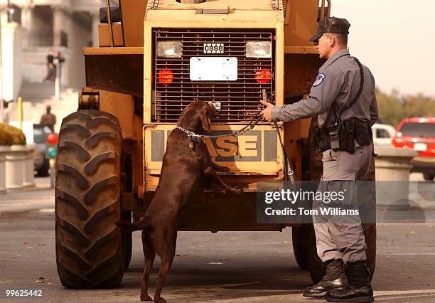 Capitol Police K-9 unit sweeps a front end loader enter the grounds of the Capitol.