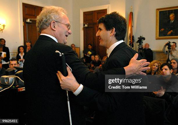 Rep. Howard Berman, D-Calif., left, greets Louis Posen, a music executive and founder of the Take Action Tour, during a news conference to kick off...