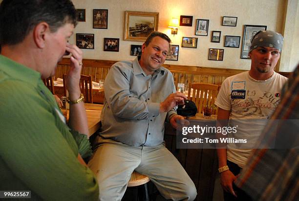 Senate candidate Jon Tester shares a laugh with his wife Sharla and son Shon at a fundraiser at the Mint Bar and Cafe in Belgrade, Montana.