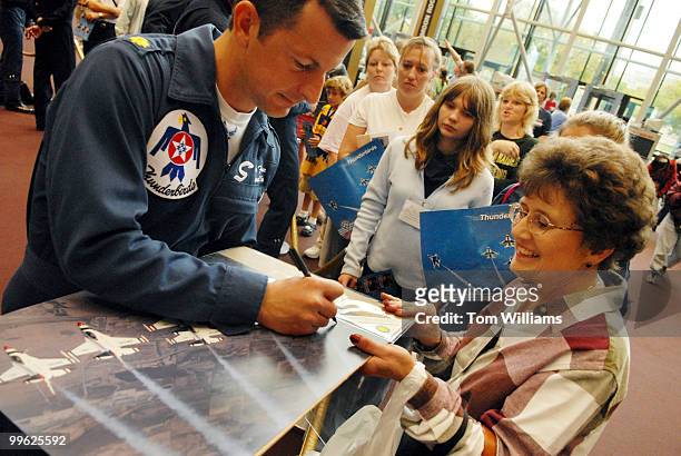 Maj. Brian Farrar of the U.S. Air Force Demonstration Squadron, "Thunderbirds," signs a picture for Jan Wood of Nebraska, at the National Air and...