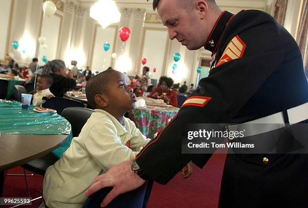 Sgt. James Conley, USMC, talks with Isaiah Samuel of Garrison Elementary in N.W., at the annual "D.C. Children's Christmas Party on the Hill," for...