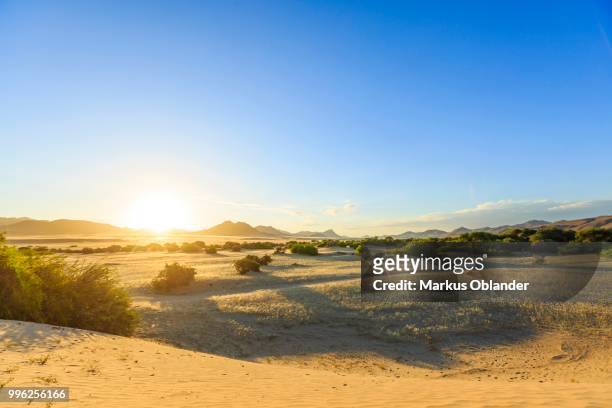 sunset at purros, kunene region, namibia - kaokoveld stock pictures, royalty-free photos & images