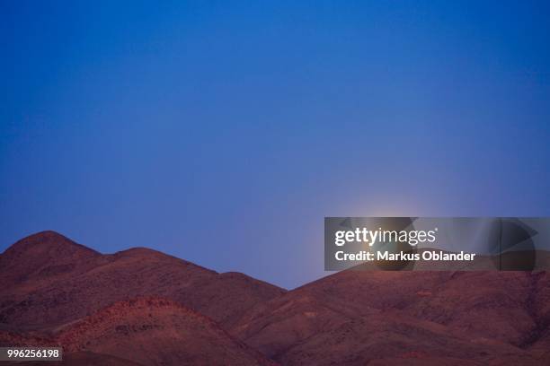 moonrise over the mountains, full moon, purros, kunene region, namibia - kunene region stock pictures, royalty-free photos & images