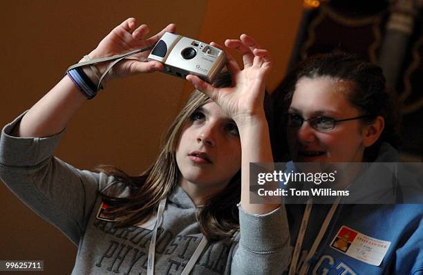 Melissa Ramage, left, and Deidre Price, eighth graders from Tunkhannock Middle School, takes pictures in the Will Rogers hallway during a tour of the...