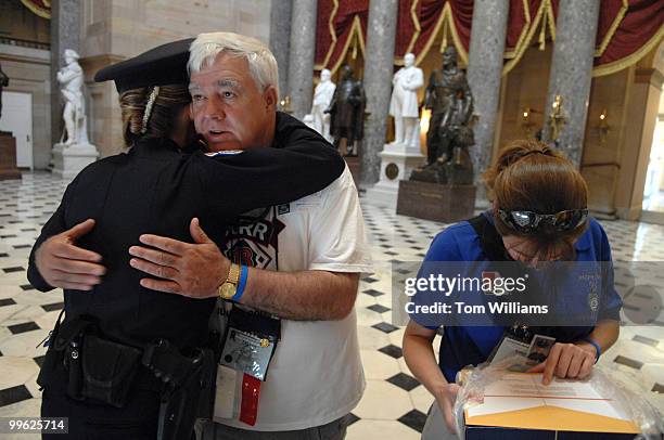 David Corr, father of Officer Joe Corr, New Hartford, N.Y. Police Department, who was killed in the line of duty 2/27/06, gets a hug from Capitol...