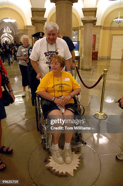 Kathy Corr, mother of Officer Joe Corr, New Hartford, N.Y. Police Department, who was killed in the line of duty 2/27/06, is pushed by her husband...