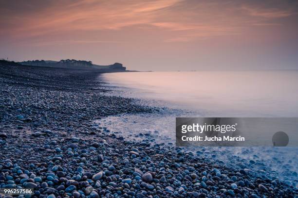 romantic sunrise on the beach in budleigh salterton - budleigh stock pictures, royalty-free photos & images