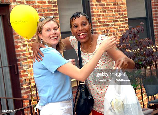 Student Sandra Rogers, right, greets one of her tutors Stephanie Rohrer, during a Washington Literacy Council cook out to honor graduates and their...