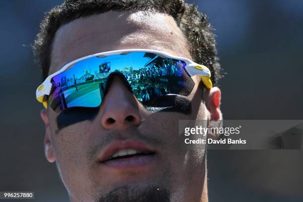 Javier Baez of the Chicago Cubs pin the dugout in a game against the Cincinnati Reds on July 8, 2018 at Wrigley Field in Chicago, Illinois. The Cubs...