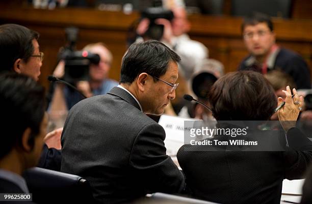Akio Toyoda, Toyota President and CEO, consults with his interpreter during his testimony before a House Oversight and Government Reform Committee on...