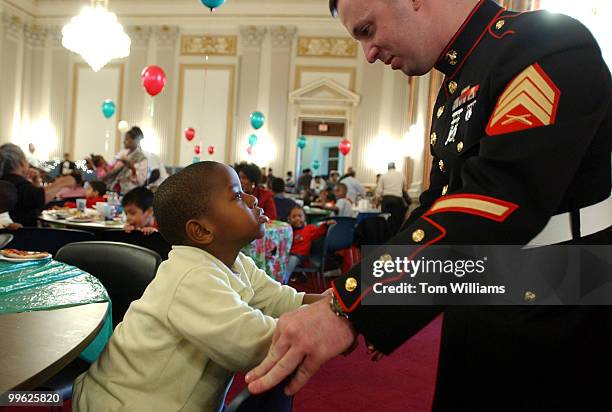 Sgt. James Conley, USMC, talks with Isaiah Samuel of Garrison Elementary in N.W., at the annual "D.C. Children's Christmas Party on the Hill," for...