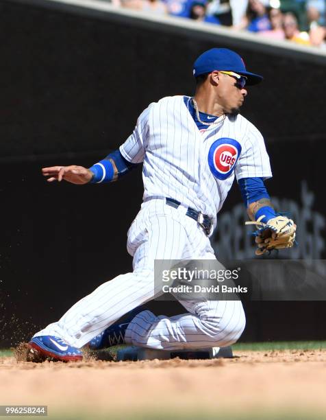 Javier Baez of the Chicago Cubs makes a play against the Cincinnati Reds on July 8, 2018 at Wrigley Field in Chicago, Illinois. The Cubs won 6-5 in...