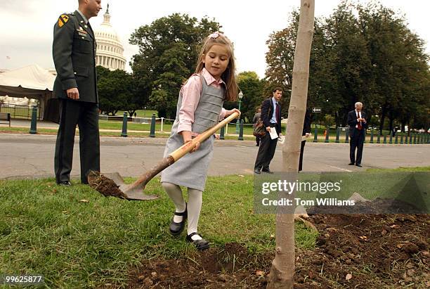 Sarah Skelton puts dirt on a Norway Maple tree that was planted in memory of her grandmother Susie Skelton, wife of Rep. Ike Skelton, D-Mo., after a...