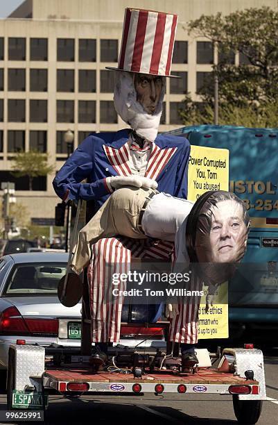 Foot statue of Uncle Sam reprimanding House Majority Leader Tom Delay, R-Texas, for Delay's ethics violations, is pulled by a car near the West Front...