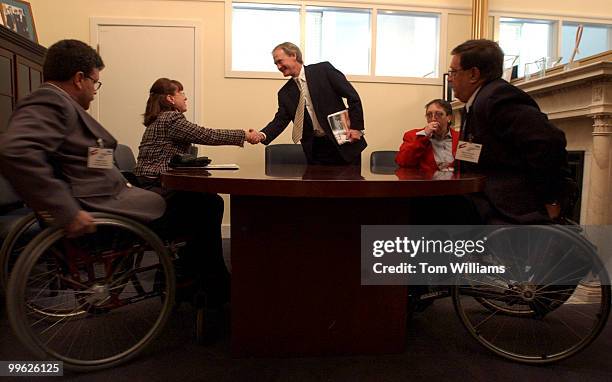 Sen. Lincoln Chafee, R-R.I., shakes hands with Rosemarie Guay, after meeting with members of the New England Chapter of Paralyzed Veterans of America...