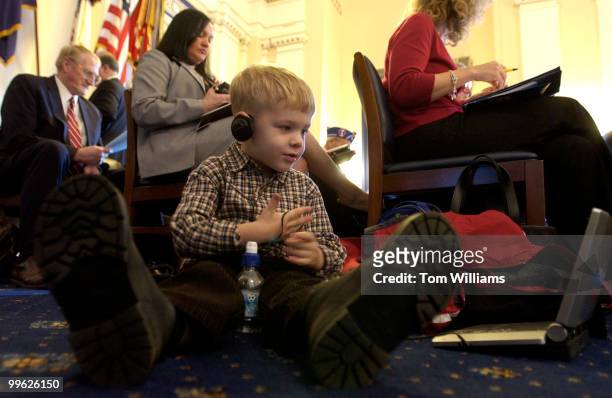 Daniel McCollum, 3 1/2, watches a DVD before a House Veterans' Affairs Committee on the underfunding of veterans' health care and benefits for...