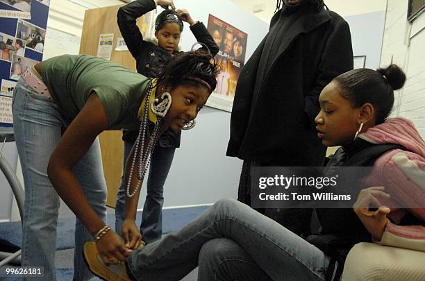 From left, Jamia Conner Tahara Marshall and Abrille Bynum prepare to shot a scene on W Street, NE, at the Multimedia Training Institute in Northeast.